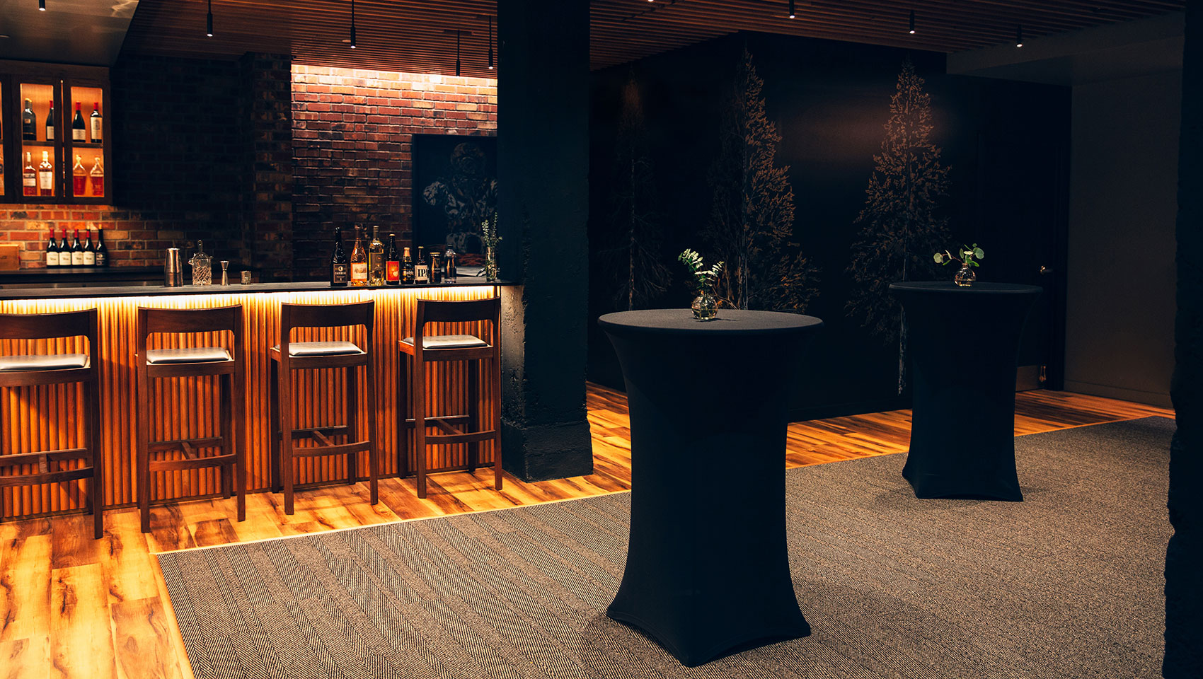 Tall tables set in front of the bar and ready for an event at Kimpton Palladian Hotel