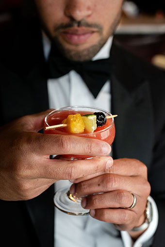 Close up of groom's hands while holding cocktail