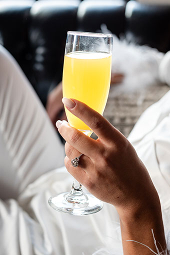 Close up of bride's ring while holding a cocktail 