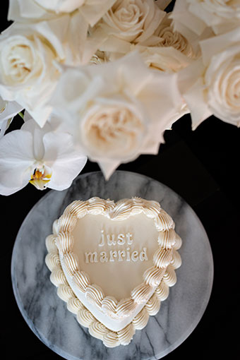 From above: small heart shaped cake that says 'Just Married'
