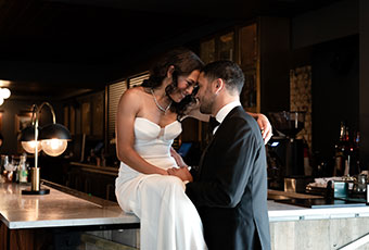 Bride and groom pose together, heads leaning on one another, looking into each others eyes